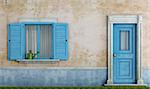 detail of an old house with blue wooden windows and front door - rendering