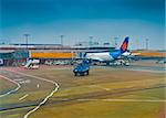 Berlin, Germany - February 14, 2013: Israeli airplane of Israir Airlines protected by German police tank and armed cops on Schonefeld airport in Berlin by a presumed terrorist attack.