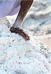 Covered by salt  bare worker's foot on salt farm on Sambhar Salt Lake, India, where salt has been farmed for a thousand years.