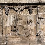 Detail of Buddhist carved relief at Borobudur temple on Java, Indonesia