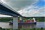 Ship Passing Under Bridge over Kiel Canal in Summer, Bornholt, Schleswig-Holstein, Germany. The Kiel Canal links the North Sea to the Baltic Sea.