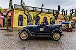 Old car used as taxi on cobblestone street in Colonia del Sacramento, Uruguay, South America