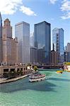 Tourist boat on the Chicago River with glass towers behind on West Wacker Drive, Chicago, Illinois, United States of America, North America