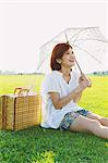 Woman Holding a Parasol In Meadow