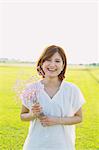 Woman Smiling With a Bouquet Of Flowers