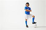 Girl Posing In Soccer Uniform With Ball