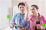 Young Man and Young Woman Working in an Office, Looking Through Glass Board, Germany