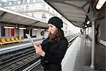 Woman using tablet computer on platform