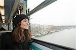 Smiling woman riding train over water