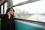 Smiling woman riding train over water