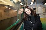 Woman listening to earphones on subway