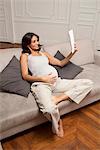 Pregnant woman using tablet computer