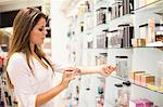 Woman trying on fragrances in store