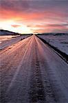 Frozen road in snowy landscape