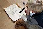 Boy writing Christmas list for Santa