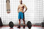 Man standing with weights in gym