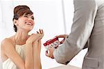 Man giving smiling girlfriend present