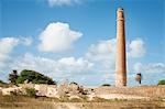 Smokestack over stone ruins