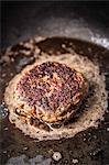 Close up of meat frying in pan