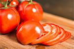 Close up of whole and sliced tomato