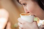 Close up of woman drinking cup of coffee