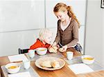 Girl serving brother lunch at table