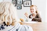 Girls eating lunch at table together