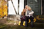 Mother and daughters sitting outdoors