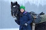 Young woman with arabo haflinger horse in snow, Upper Palatinate, Germany, Europe