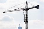 Silhouette of crane in blue sky