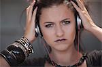 Angry teenage girl wearing headphones