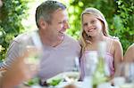 Father and daughter smiling at table