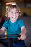 Boy riding go-kart in garage