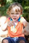 Boy punching the air outdoors