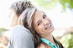 Smiling girl leaning on boyfriend