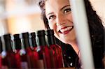 Smiling woman shopping for vinegar