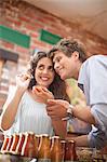 Couple tasting preserves in grocery