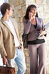 Business people standing in walkway