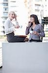 Businesswomen having coffee on balcony