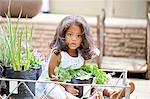 Girl holding potted plant at nursery