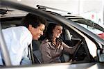 Salesman showing woman new car