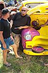 Mechanics working on colorful car