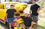 Men smiling with colorful car