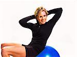 Smiling woman using exercise ball