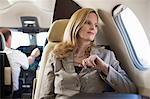 Businesswoman sitting in airplane