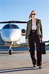 Businesswoman on airplane runway