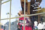 Waitress putting open sign in window