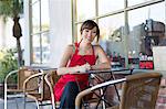 Woman writing at cafe table