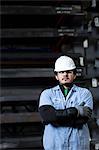 Worker standing in metal plant