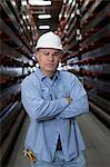 Worker standing in metal plant